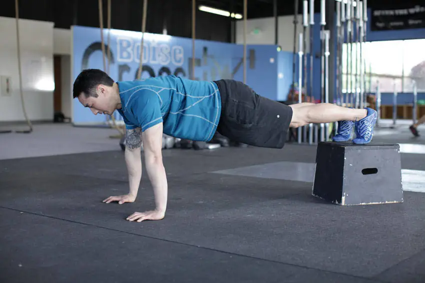 Feet-Up Floor Grind (Elevated Pec Pounder)